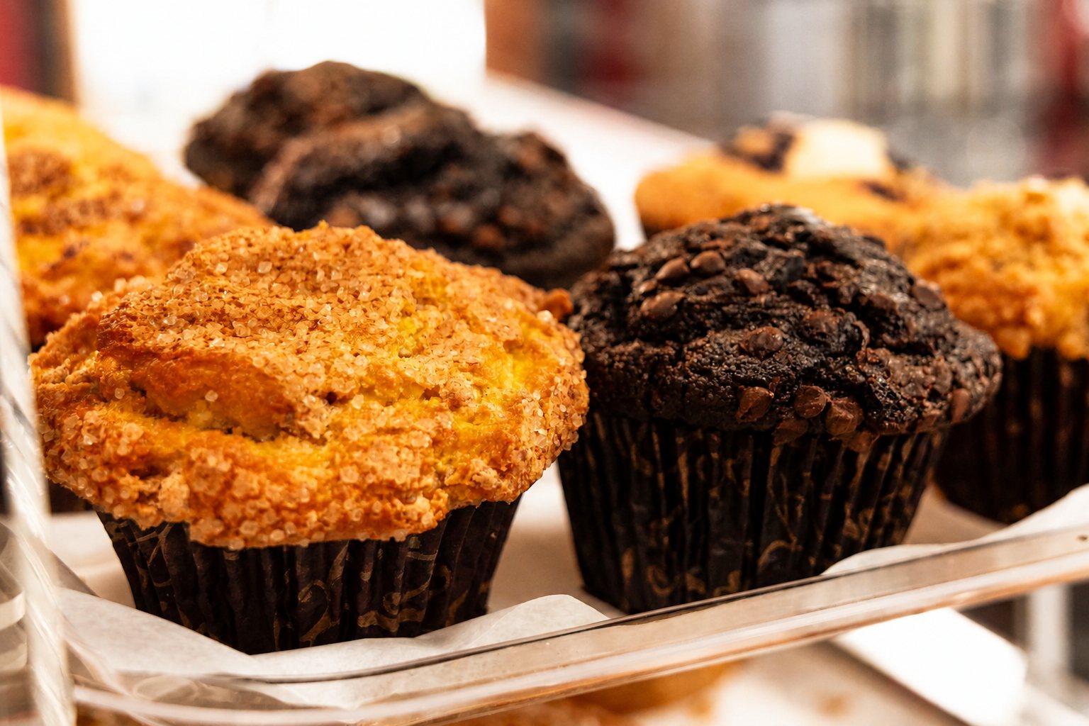 Muffins in the pastry case by the register