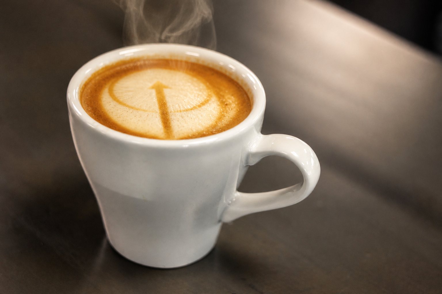 Latte art poured in the shape of the High Grounds arrow